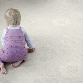 Light coloured flooring with a baby crawling