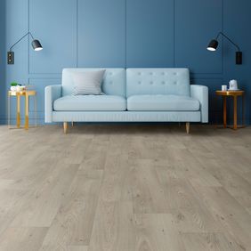 Oak effect flooring in large space with a light blue couch