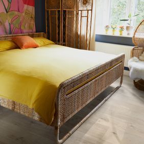 Oak effect flooring laid in a bedroom with an abstract picture on the wall