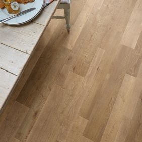 Close up of dining table and chair featuring light timber wood effect flooring in Salvaged Timber 
