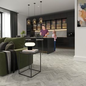 Oak effect parquet flooring laid in an open plan living/ dining space 