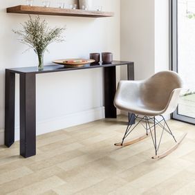 Light stone effect flooring in a home reading space with table and chair 