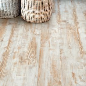 Wicker potatoe storage baskets in kitchen with light wood effect flooring