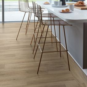 Breakfast bar with stools featuring light wood effect flooring 