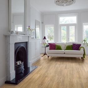 light oak wood effect flooring in Living room with white sofa and black fireplace 