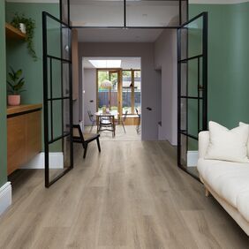 Light coloured oak effect flooring laid in an open plan living space