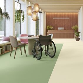 green and cream flooring in a care home, elderly, wheel chair 