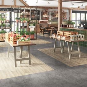 Grey stone and light wood effect flooring with zonal areas in a Garden centre indoor fruit and veg store