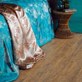 Close up of dark wood effect flooring random laid planks in Wild Amber Oak 