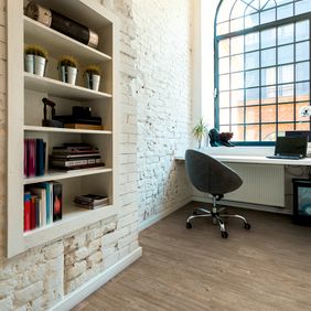 Rustic light brown wood effect flooring in a office space 