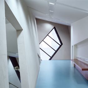 Quirky corridor area with a bench and light blue flooring