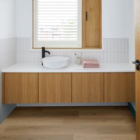 Oak effect flooring in a residential bathroom decorated in a scandi vibe