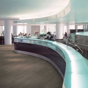 Reception area with dark wood effect flooring 