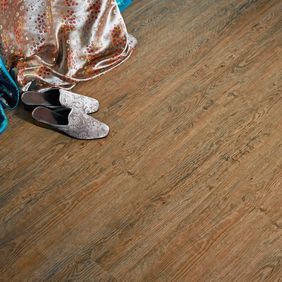 Close up of dark wood effect flooring in Wild Amber Oak random straight laid 
