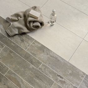  Close up of slate effect flooring in Dual width tiles, cut in 1/2 and 1/4 lengthways, alongside White Metalstone with Pearl and Grey Grouting Strip.