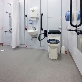 Grey safety floooring in a disabled toilet and shower room 