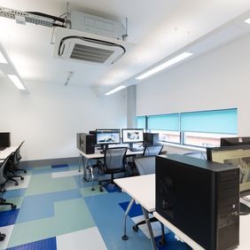 Classroom with computers and mixed coloured flooring