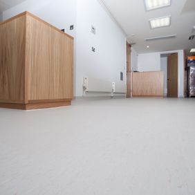 Large open corridor with light coloured flooring