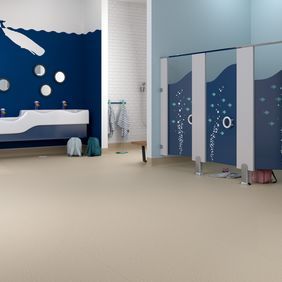 Large public toilets with neutral coloured flooring