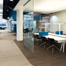 Modern office space divided by different coloured flooring