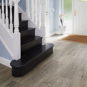 Dark oak effect flooring in a large hallway 