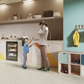 Oak effect flooring laid in a nursery playroom with people