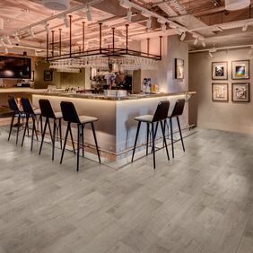 Grey oak effect flooring in a bar area