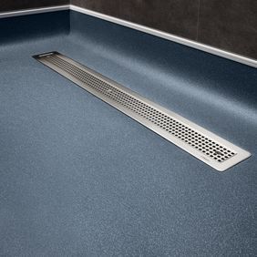 Dark blue safety flooring featured around a shower drain 