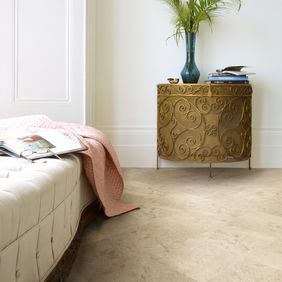 Stone effect flooring Straight laid at 45o with gold accessories and large cushioned pouffe