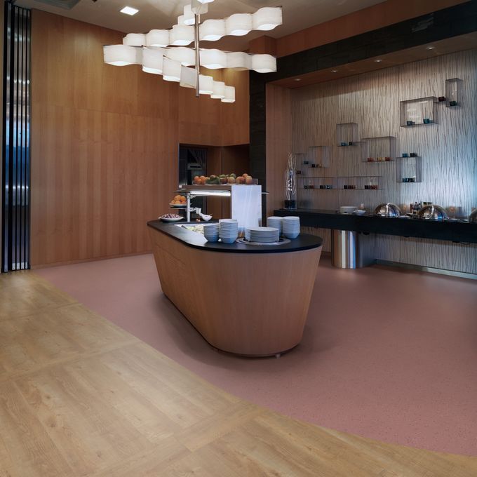Self service breakfast bar area with Oak effect flooring laid alongside Polysafe Verona 