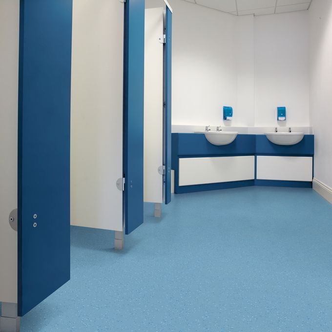 Light blue decorative chip safety flooring in public toilets