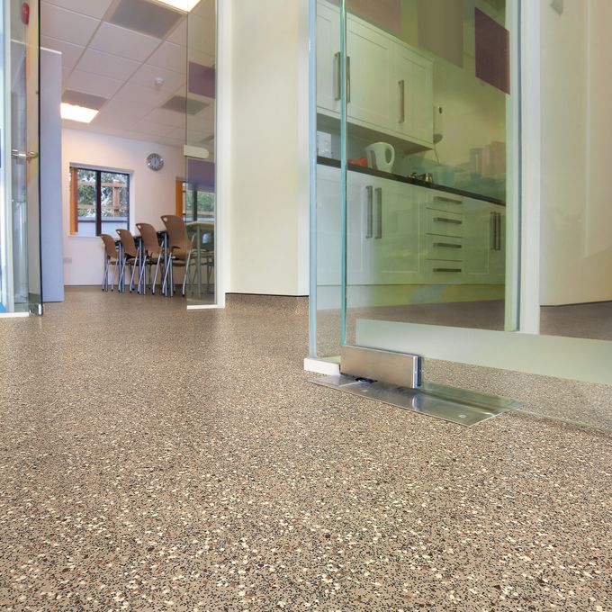 Neutral coloured safety flooring in a corridor 