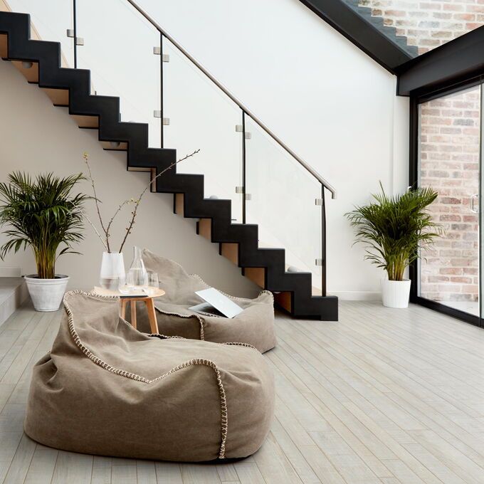 TLC Massimo in New England Assorted Oak laid in living room with two beige beanbags 