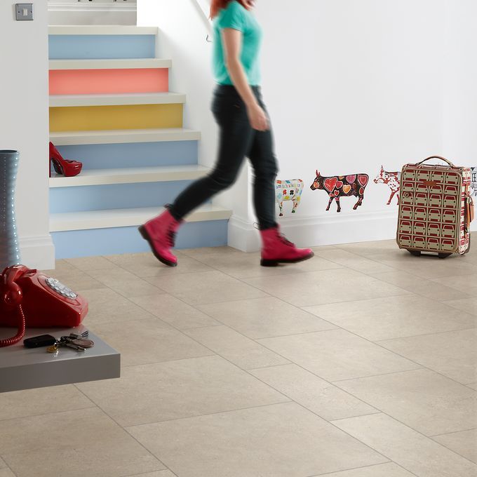 Light stone effect flooring laid in a Random width tile design featuring full, two third & third cut tiles, with Grey Grouting Strip surrounded by colourful wall stickers and staircase 