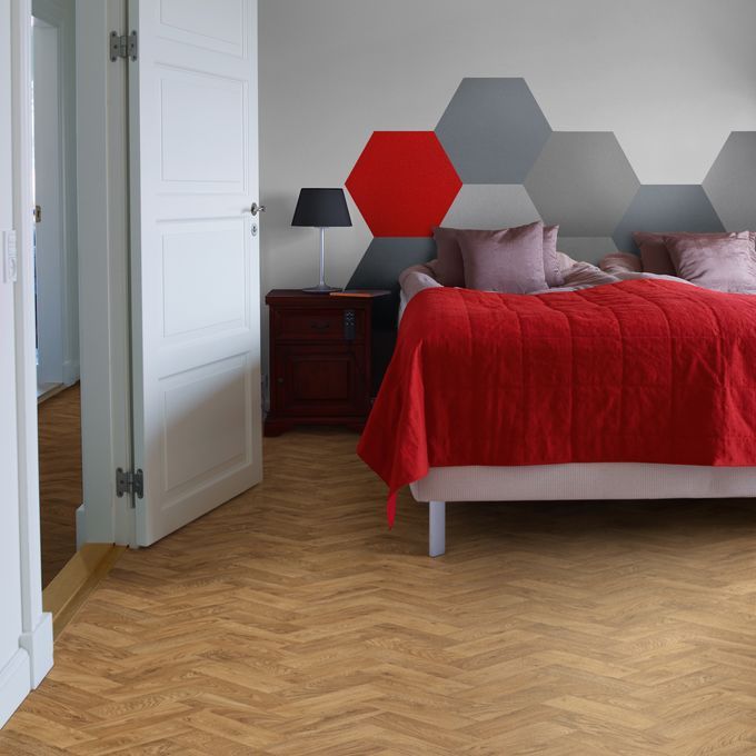 Oak parquet wood effect flooring in a trendy bedroom 