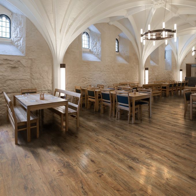 Resturant dining with open brick walls and brown oak effect flooring 