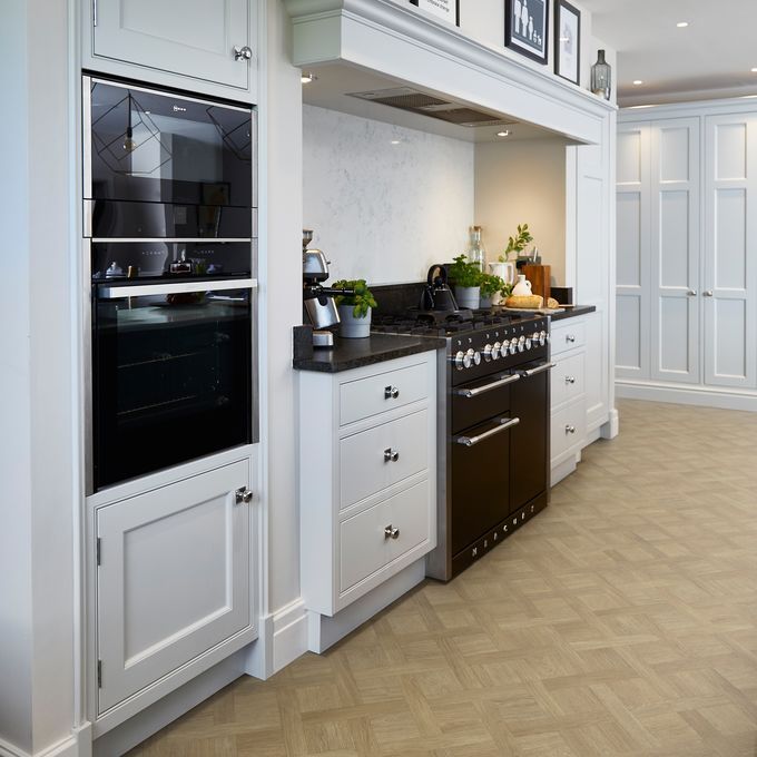 Wood effect flooring in a basket weave style laid in a large kitchen