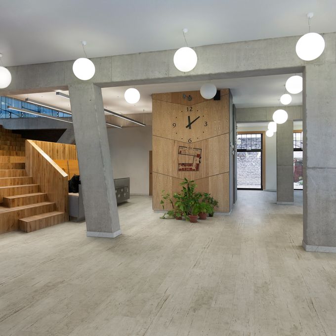 Light concrete effect flooring in a commercial corridor 