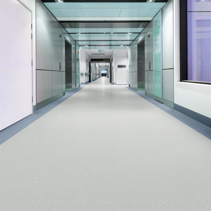 Light colour safety flooring in a long commercial corridor