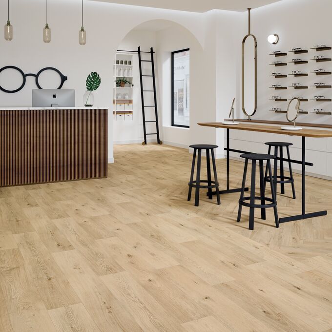 Oak effect flooring laid in a store with parquet style and straight plank