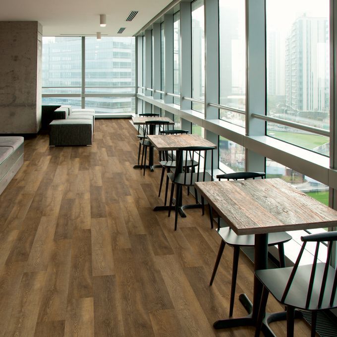 Dark oak effect flooring straight laid in a restaurant dining area