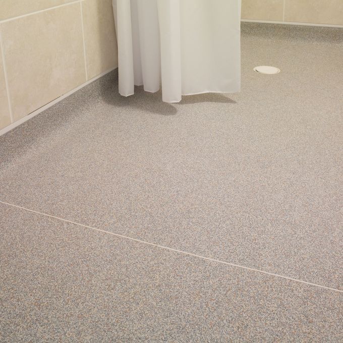 Close up of wet room with light grey flooring