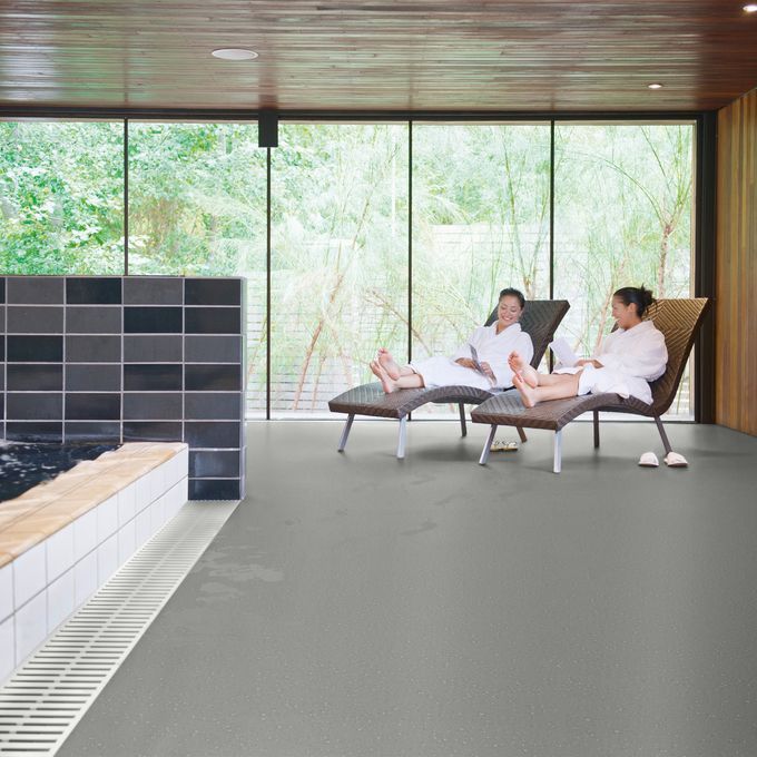 Relaxing area next to swimming pool with loungers