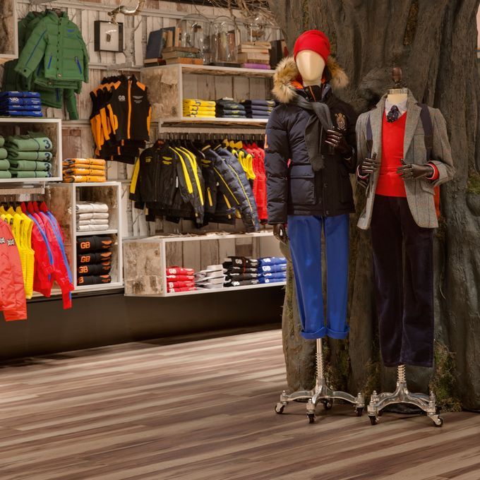 Outerwear retail shop with a walnut effect flooring 