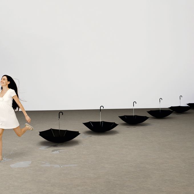 women in a room with umbrellas featuring grey concrete effect flooring 
