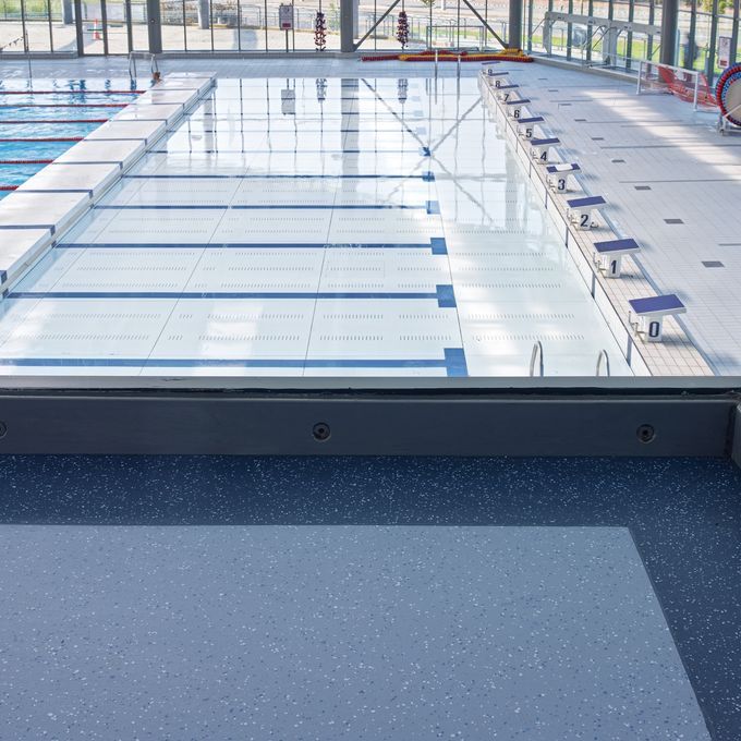 Dark blue safety flooring in a Public swimming baths spectator area