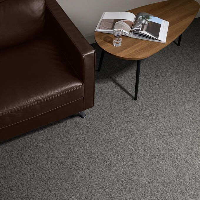 Polyflor Expona Fabrik in Black laid next to a table and chair 