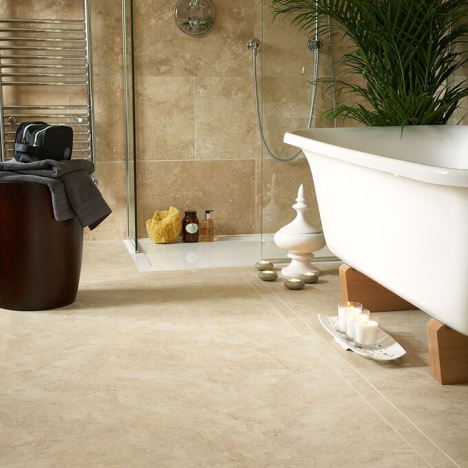 Modern bathroom featuring stone effect flooring in Claissic Yorkstone Straight laid with 1/4 tile and Cream Feature Strip tramline perimeter. 