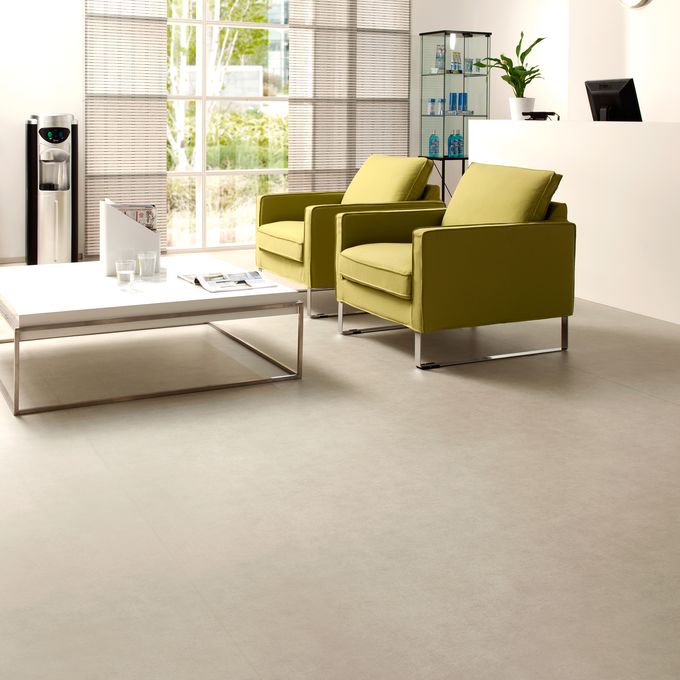 Light stone effect safety flooring in a Modern waiting area with green chairs