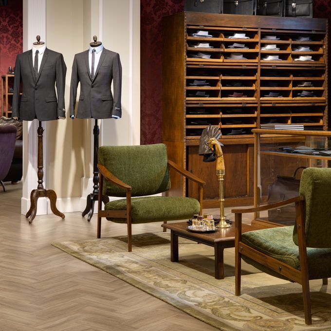 High end mens retail with seating area and Oak Herringbone design flooring